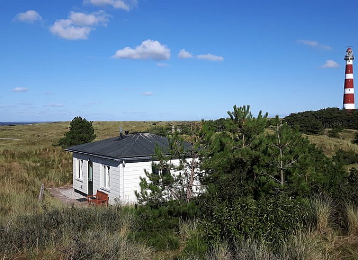 Vakantiehuisje in Hollum op Ameland met uitzicht op de vuurtoren, ideaal voor een ontspannen verblijf op de Waddeneilanden.