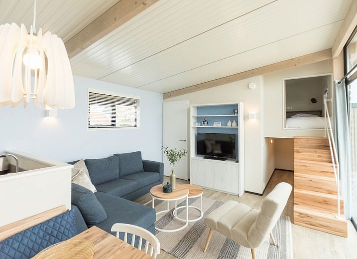 Oerd Family vacation home in Hollum, Ameland with modern veranda and wooden facades for a relaxing stay in the Wadden Islands.