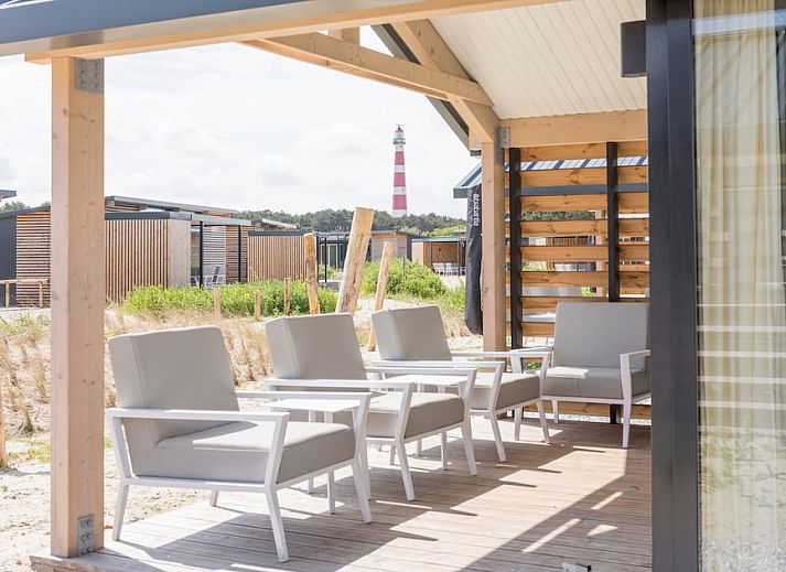 Lichte woonkamer van Lighthouse Adventure vakantiehuis in Hollum, Ameland, met uitzicht op de natuur.