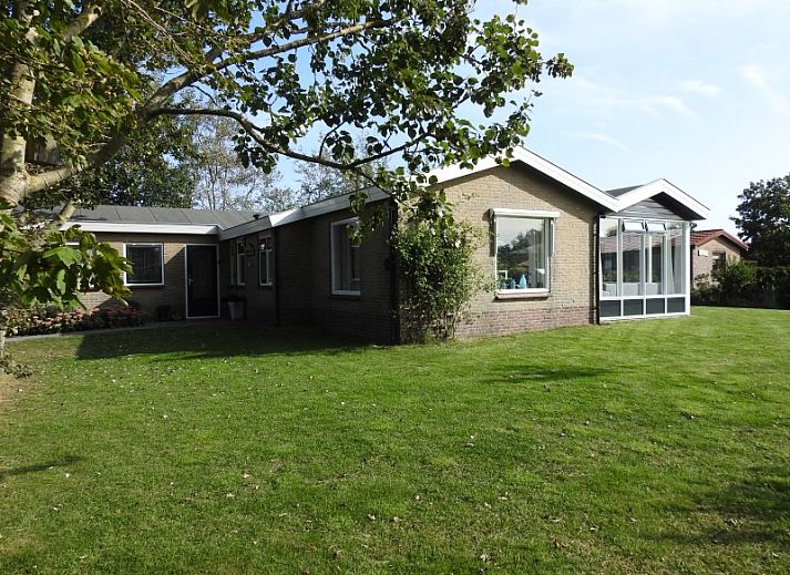 Spacious lawn with terrace at vacation home Strandloper in Hollum, Ameland, Wadden Islands.