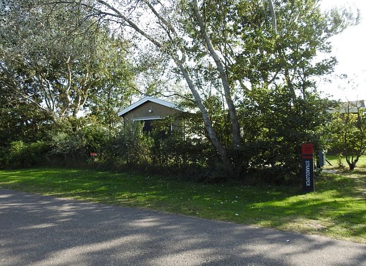 Spacious lawn with terrace at vacation home Strandloper in Hollum, Ameland, Wadden Islands.