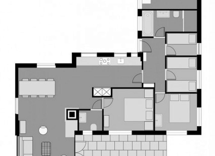 Entrance to Strandloper vacation home in Hollum, Ameland, surrounded by greenery.