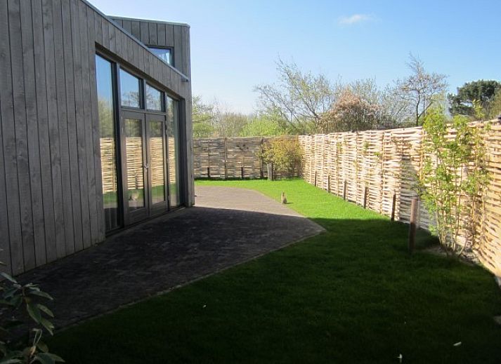 Duyngolf 71 vakantiehuis in Hollum Ameland met moderne houten gevel en grote ramen.