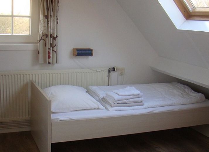 Cozy living room of Ilsebil vacation home in Hollum, Ameland with comfortable seating.