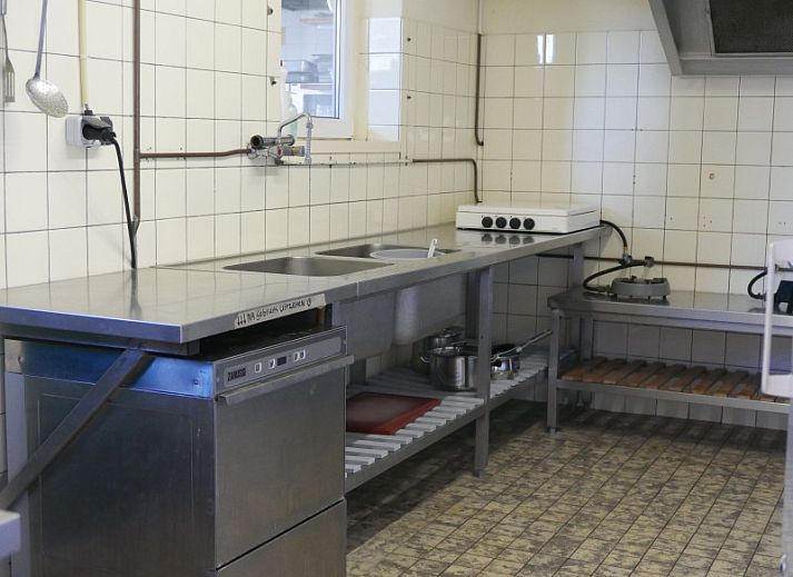 Terrace at The Achterschuur vacation home in Hollum, Ameland with seating for relaxation.