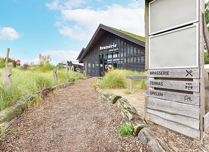 Lichte woonkamer in Vrijstaande woning in Hollum, Ameland met uitzicht op de omgeving.