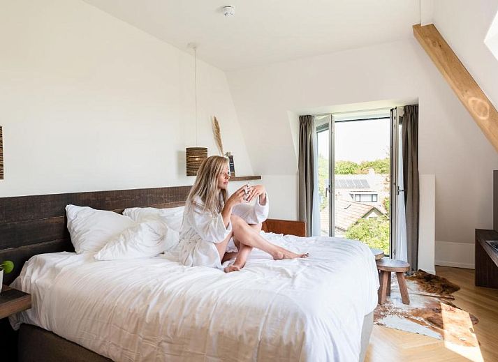 Elegante badkamer in Van Heeckeren Hotel Nes, Ameland, met bad en moderne voorzieningen.