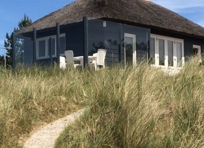 Parnassia Bungalow in Nes, Ameland mit Reetdach und Terrasse inmitten der Natur.