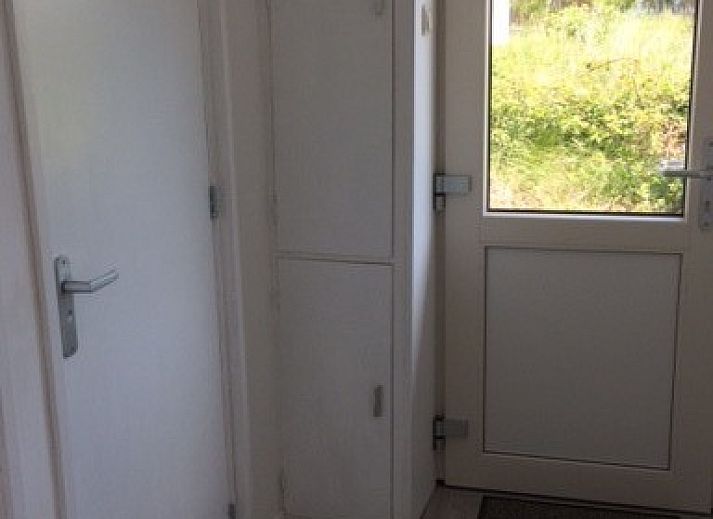 Terrasse des Parnassia-Bungalows in Nes, Ameland mit Blick auf die gruene Umgebung.