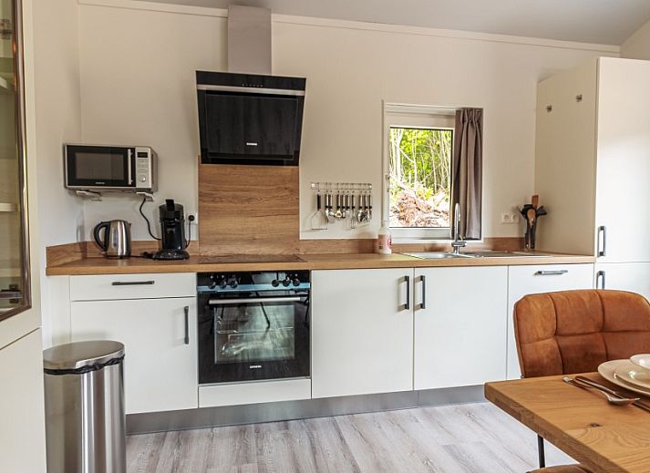 Explore the picturesque surroundings of Nesserduinen 42B, a vacation home in Nes, Ameland, with beautiful greenery and rustic paths.