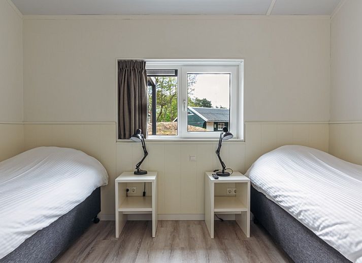 Relax in the cozy living room of Nesserduinen 42B, a vacation home in Nes, Ameland, with modern furnishings and plenty of light.