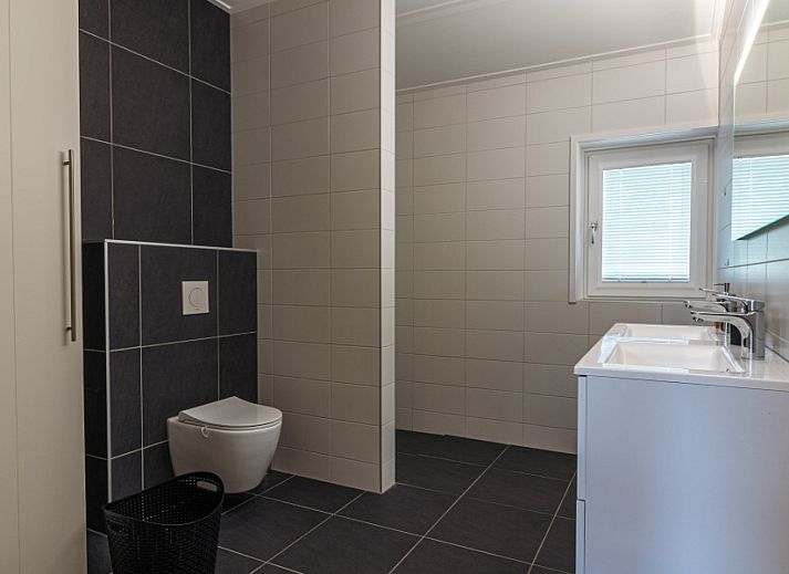 Cozy living room of Nesserduinen 42D, vacation home in Nes, Ameland with comfortable seating area.