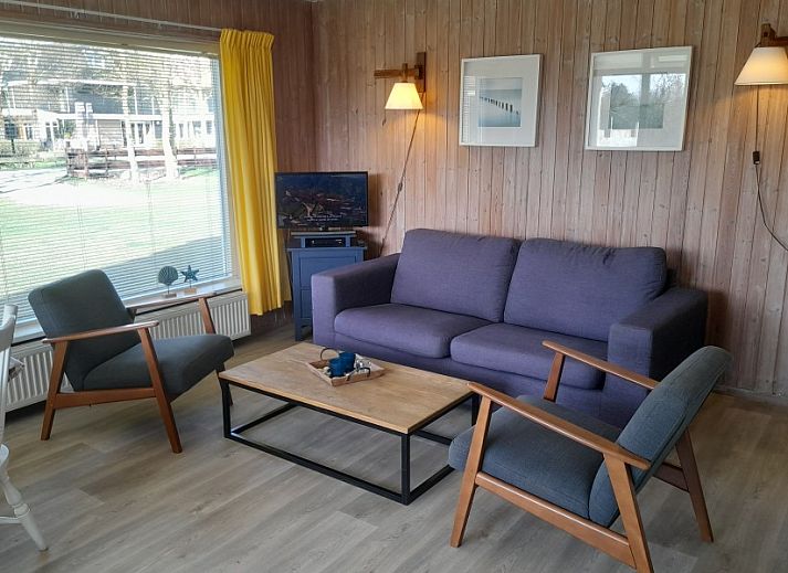 Geertje-Aaltje bungalow in Nes, Ameland with green garden and terrace for relaxation.