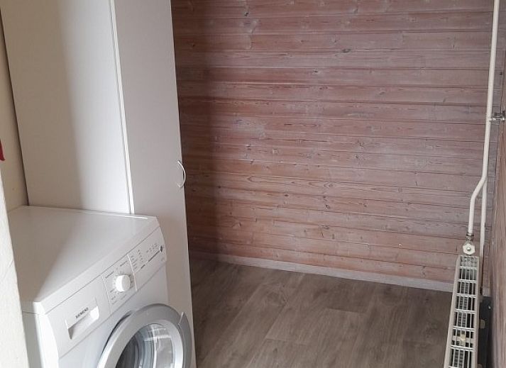 Cozy living room in Geertje-Aaltje vacation home, Nes, Ameland with comfortable seating area.