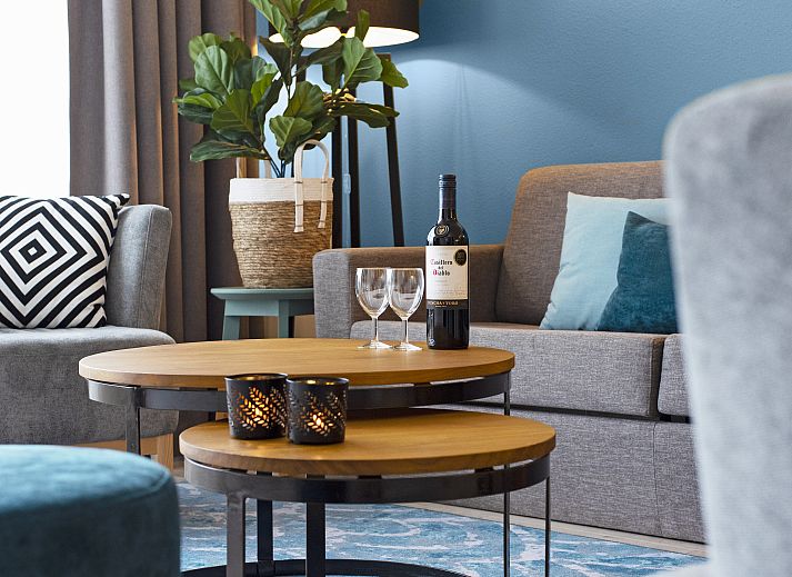 Modern interior space of Ameland State apartment in Nes, Ameland, with open kitchen and sitting area.