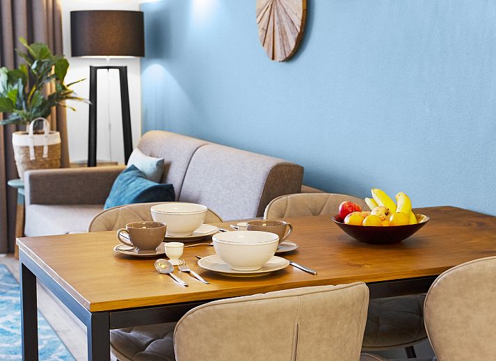 Modern interior space of Ameland State apartment in Nes, Ameland, with open kitchen and sitting area.