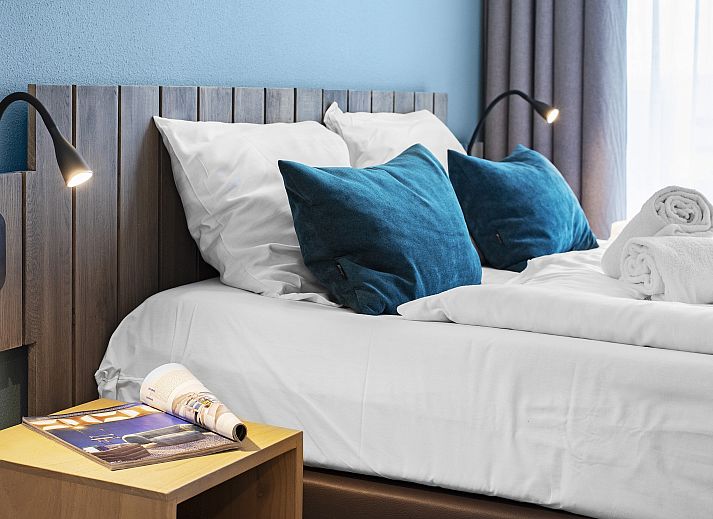 Modern interior space of Ameland State apartment in Nes, Ameland, with open kitchen and sitting area.