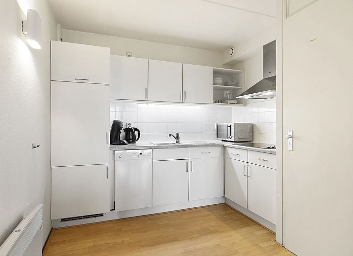 Gezellige woonkamer in Ameland State appartement in Nes, Ameland, met uitzicht op de natuur.