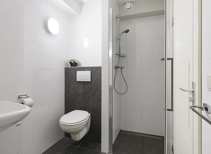 Balkon van Ameland State 2-persoons appartement in Nes, Ameland, met uitzicht op de groene omgeving.