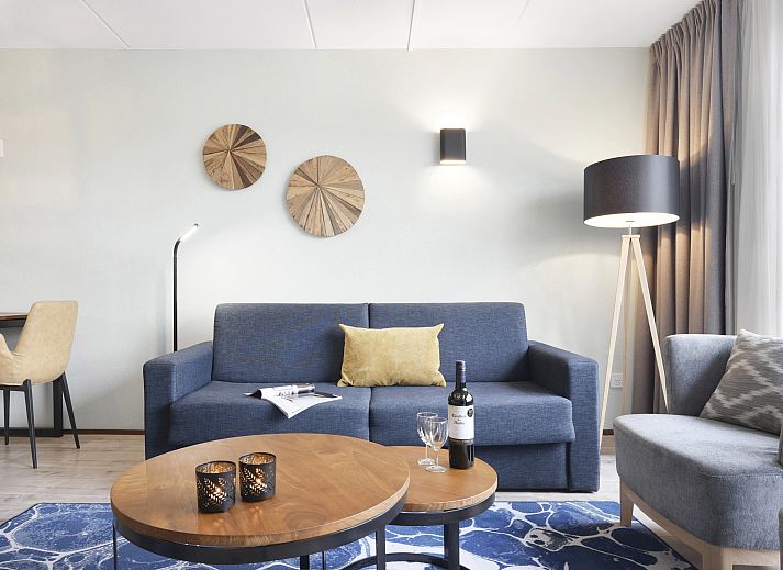 Cozy sitting area in Ameland State apartment in Nes, Ameland, overlooking green surroundings.