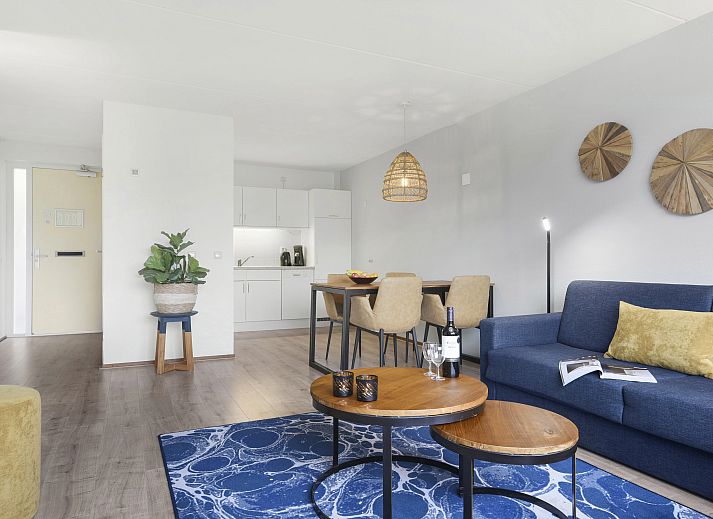 Cozy sitting area in Ameland State apartment in Nes, Ameland, overlooking green surroundings.