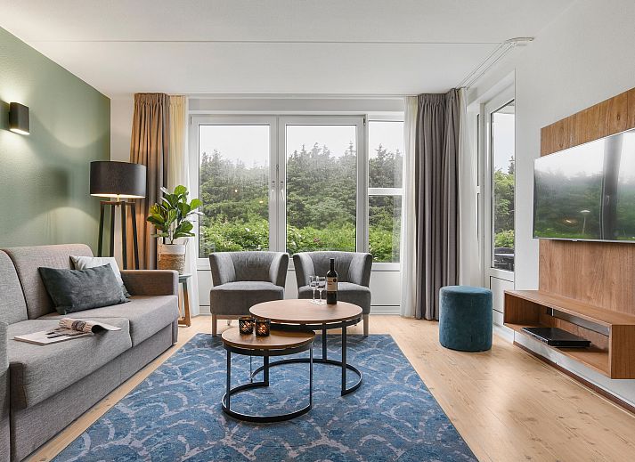 Cozy living room of Ameland State 4-person apartment in Nes, Ameland overlooking nature.