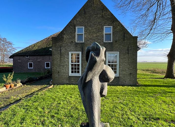 Ruime binnenruimte in Vakantiehuisje in Piaam met houten balken en moderne inrichting, gelegen aan het IJsselmeer.