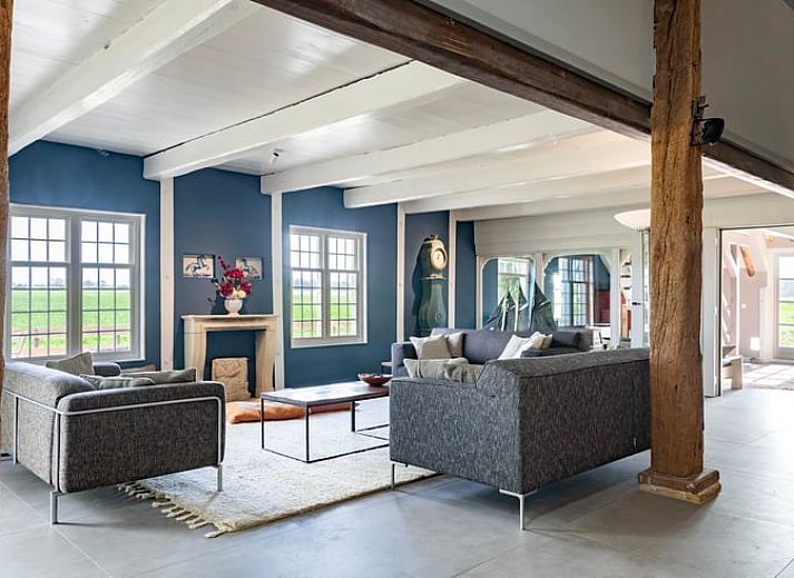 Buitenkant van Vakantiehuisje in Piaam omgeven door groene natuur en bomen, ideaal voor een ontspannen verblijf aan de Friese meren.