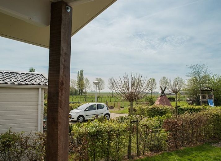 Gezellige binnenruimte van de lodge in Warns met houtkachel en eetruimte, nabij het IJsselmeer en de Friese meren.