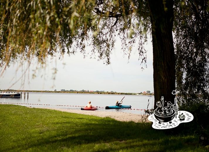 Cottage in Heeg, vacation home in Frisian lakes overlooking green surroundings and terrace, ideal for nature lovers.