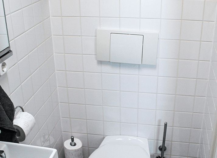 Spacious dining room in Holiday Home in Oudega, located on Lake Heeg in the Frisian Lakes, with a robust wooden table and modern furnishings.