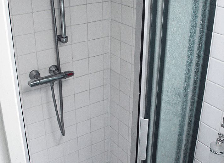 Spacious dining room in Holiday Home in Oudega, located on Lake Heeg in the Frisian Lakes, with a robust wooden table and modern furnishings.