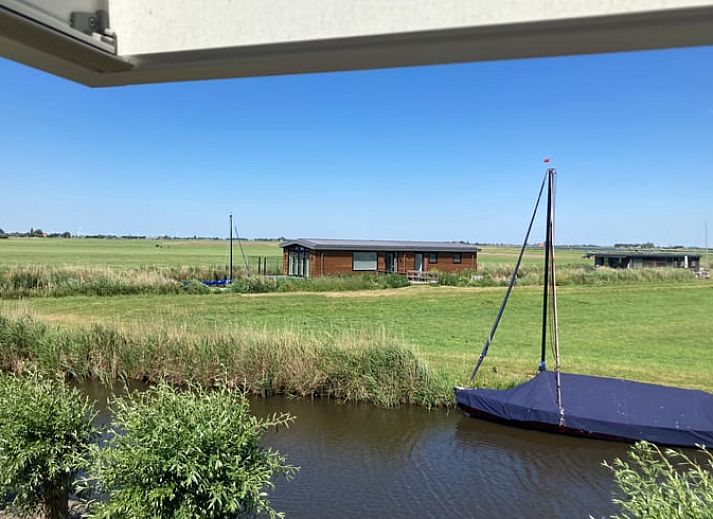 Gezellig vakantiehuis in Gaastmeer, gelegen aan de Fluessen met directe toegang tot het water en omringd door groene bomen.