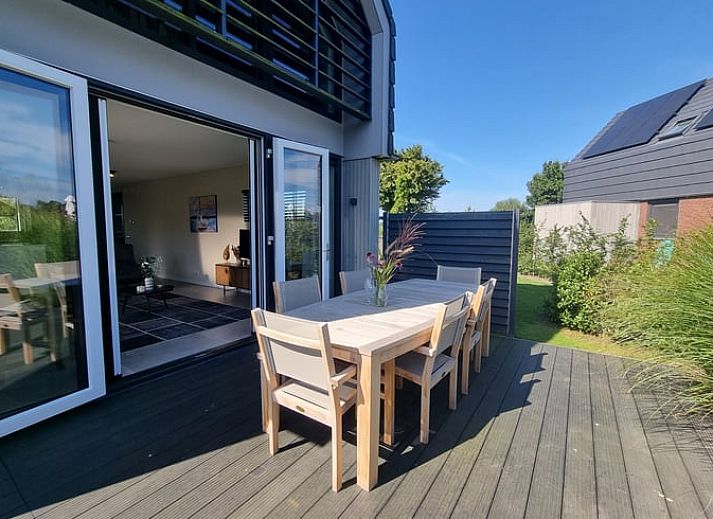 Geraeumige Sitzecke im Ferienhaus in Balk mit bequemen Stuehlen und viel natuerlichem Licht, in der Naehe von Slotermeer.