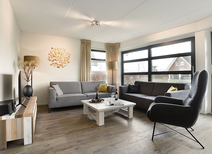 Spacious living room of Waterpark Terherne 8-person water house Opvaart 8C1, vacation home in Terherne, Frisian lakes, with modern furnishings.