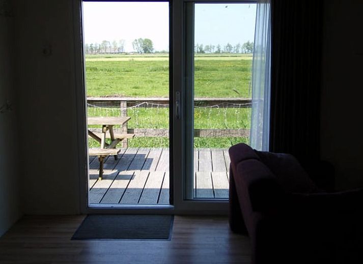 Veranda of Cottage in Terherne overlooking green fields, located in Sneekermeer, Frisian lakes.