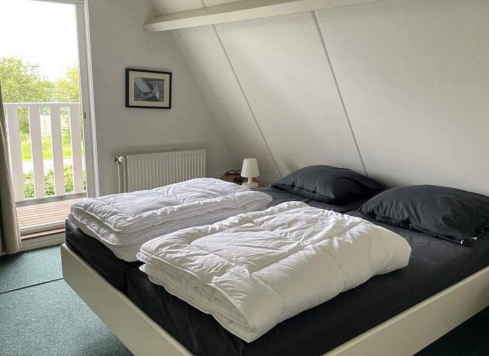 Aerial view of Bungalow Sneekermeer with sailboat in Goingarijp, located on the waters of the Frisian lakes for a relaxing vacation.