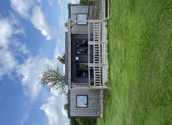 Ferienhaus Natuurlijk de Veenhoop in De Veenhoop, ein charmantes Ferienhaus umgeben von gruener Natur und blauem Himmel.