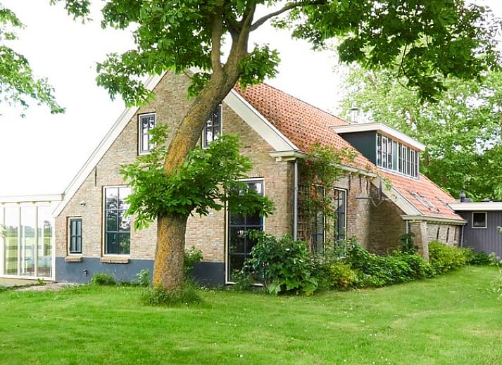 Vacation home in Kollumerpomp, located in the green nature of Lauwersmeer, offers a charming exterior with traditional Frisian architecture.