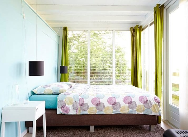 Cozy living room in Holiday Home in Kollumerpomp, Lauwersmeer, with fireplace and comfortable seating area for relaxation.
