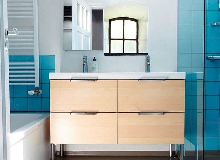 Cozy living room in Holiday Home in Kollumerpomp, Lauwersmeer, with fireplace and comfortable seating area for relaxation.