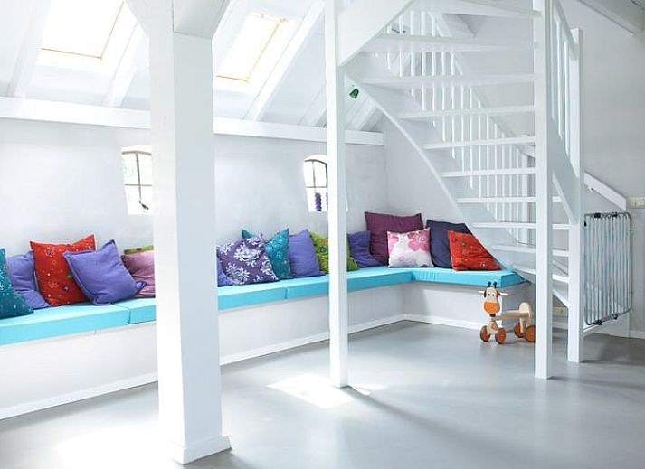 Cozy living room in Holiday Home in Kollumerpomp, Lauwersmeer, with fireplace and comfortable seating area for relaxation.