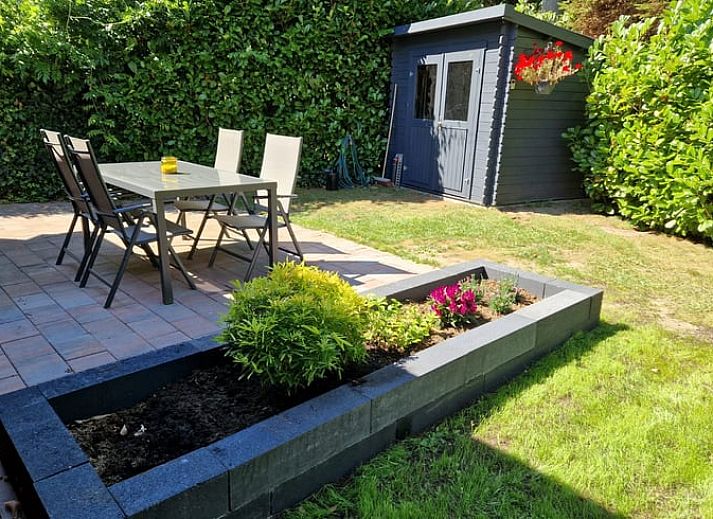 Cozy indoor area of Huisje in Spier, vacation home in Central Drenthe, with wooden interior and comfortable sitting area.