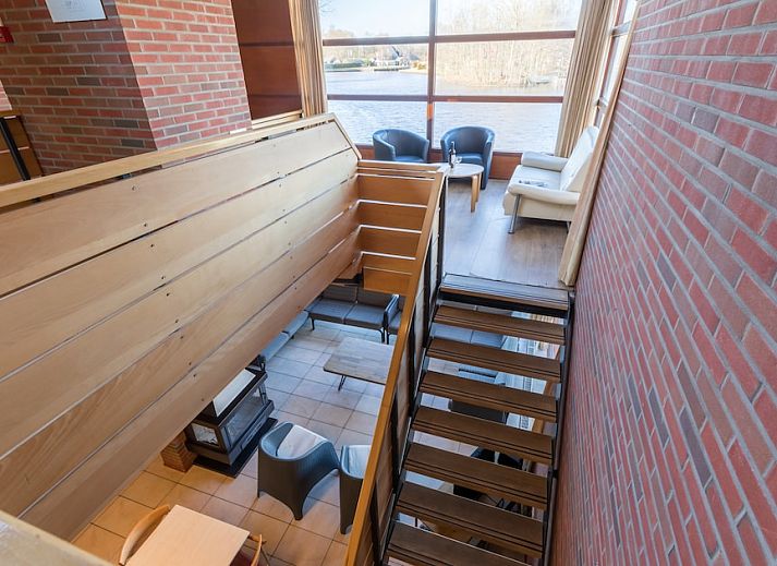 Cozy living room in Meander 36, Gasselternijveen, with comfortable seating and fireplace.