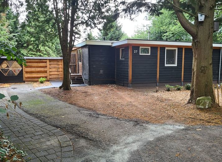 Cozy living room in Holiday Home in Gasselte, Middle Drenthe, with wooden dining table and modern furnishings.