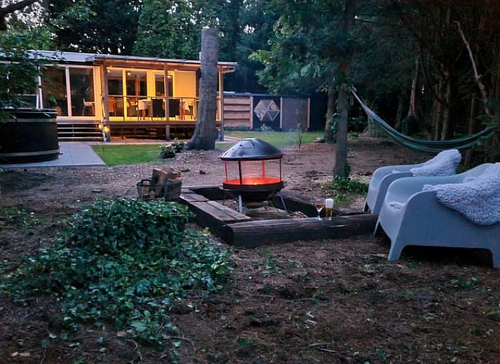 Cozy living room in Holiday Home in Gasselte, Middle Drenthe, with wooden dining table and modern furnishings.