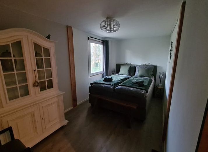 Snowy terrace of Holiday cottage in Gasselte, Drenthe, with serene winter nature and an inviting porch.