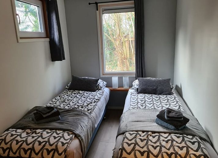 Snowy terrace of Holiday cottage in Gasselte, Drenthe, with serene winter nature and an inviting porch.