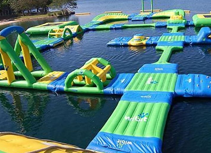 Cozy living room in Holiday Home in Gasselte, Drenthe, with comfortable sofa and view of green garden.