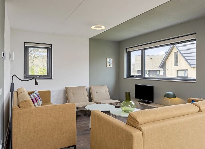 Bright living room in 8-person house 8C, Westerbork, with views of the surroundings.